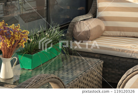 Wicker patio furniture on timber deck in sunny summer day. Garden furniture for relaxing.  119120326
