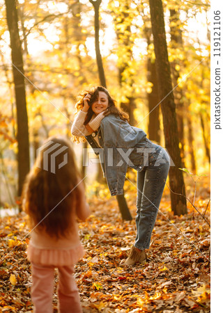 Portrait of happy mother and daughter in autumn forest at sunset. . Autumn women. 119121106
