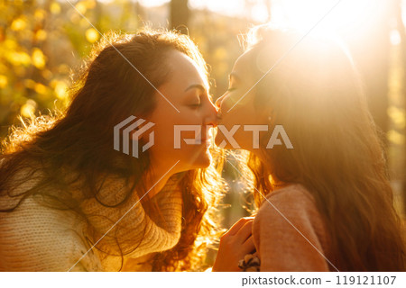 Portrait of happy mother and daughter in autumn forest at sunset. . Autumn women. 119121107
