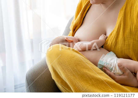 Mothe sitting at home woman breastfeeding infant kid Mothe sitting at home woman breastfeeding infant kid 119121177