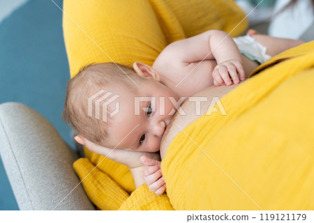 Anonymous woman breastfeeding newborn kid in the nursery Anonymous woman breastfeeding newborn kid in the nursery 119121179
