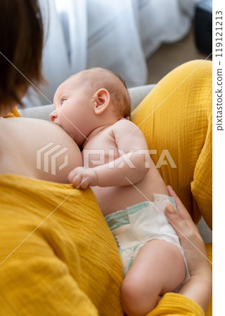 Mothe sitting at home woman breastfeeding infant kid 119121213