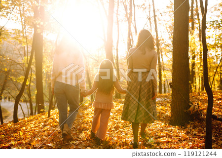 The homosexual family playing with her daughter in the autumn forest. The adventure is more fun. The homosexual family playing with her daughter in the autumn forest. The adventure is more fun. 119121244