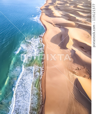 Image of waves crashing on a sandy beach 119121377