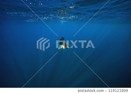 underwater photographer in the deep blue sea 119121809