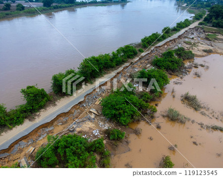 Landslides caused by heavy rains have caused the asphalt roads to crack. Natural disasters from flooding have damaged and cut off the road surface along the river. Landslides caused by heavy rains have caused the asphalt roads to crack. Natural disasters from flooding have damaged and cut off the road surface along the river. 119123545