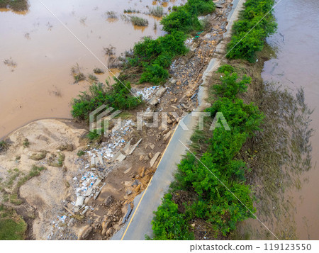 Landslides caused by heavy rains have caused the asphalt roads to crack. Natural disasters from flooding have damaged and cut off the road surface along the river. Landslides caused by heavy rains have caused the asphalt roads to crack. Natural disasters from flooding have damaged and cut off the road surface along the river. 119123550