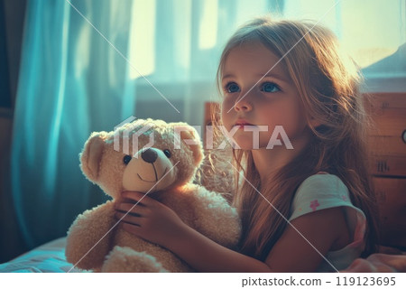 closeup of Cute little girl hugging a teddy bear Safe Toys and Gifts Month concept 119123695