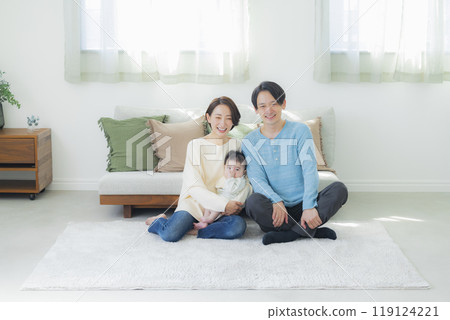 A family relaxing in the living room A family relaxing in the living room 119124221