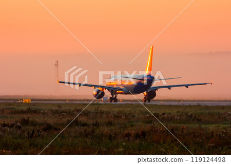 Passenger aircraft on the runway in the early foggy morning Passenger aircraft on the runway in the early foggy morning 119124498