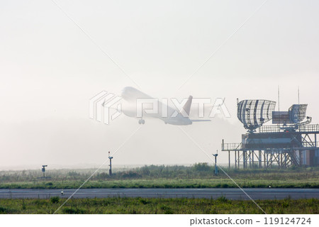 Passenger airplane taking off in fog Passenger airplane taking off in fog 119124724
