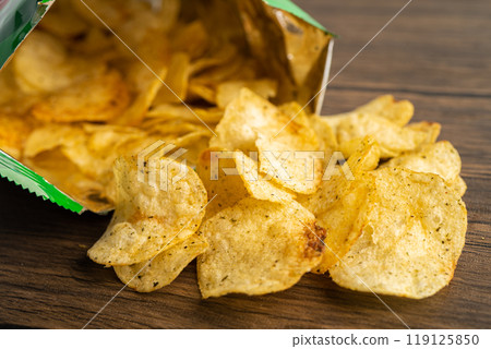 Potato chips, delicious spicy for crips, thin slice deep fried snack fast food in open bag. Potato chips, delicious spicy for crips, thin slice deep fried snack fast food in open bag. 119125850