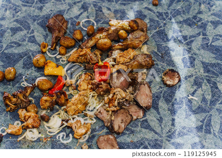 Food on the floor. Meat and vegetables fell on the carpet in the restaurant. Food on the floor. Meat and vegetables fell on the carpet in the restaurant. 119125945