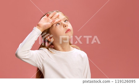 Little girl raises her hand to her forehead as if checking for sun or feeling tired, showing dramatic, slightly exaggerated emotion of exhaustion or frustration. 119126095