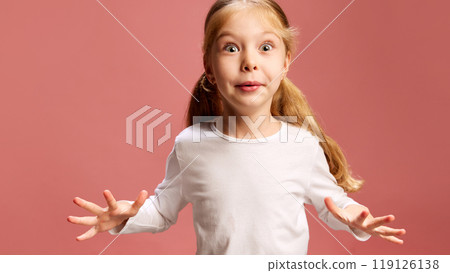 Eyes wide and excited, little girl reacts with surprise against pastel ink background. Expression of enthusiasm and curiosity, full of energy. 119126138