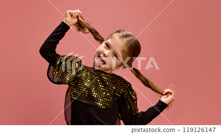 Playful girl sticks her tongue out while holding her pigtails, her sequin top sparkling as she enjoys fun against pastel ink background. Joy and energy 119126147