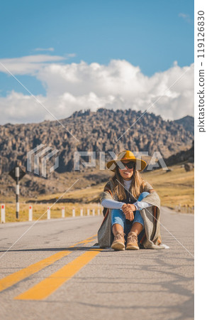 Girl sitting on the andes route in Huayllay Stone Forest, Peru. Traveling through the peruvian andes. Girl sitting on the andes route in Huayllay Stone Forest, Peru. Traveling through the peruvian andes. 119126830