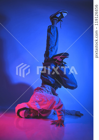 A man is doing a handstand on a white background. Urban concept. 119126856