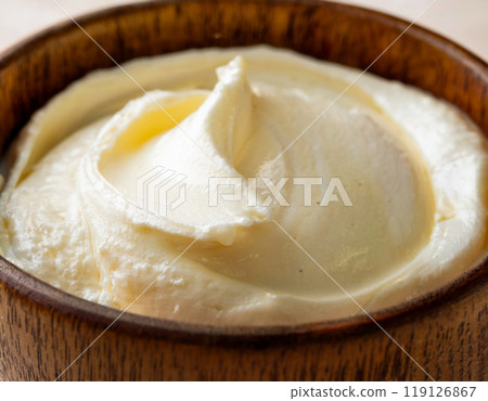Whipped butter in a wooden bowl 119126867