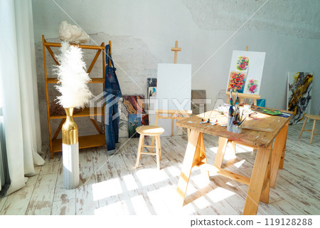 A Bright and Innovative Art Studio Featuring Beautiful Wooden Furniture along with Captivating Paintings 119128288