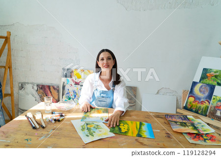 A Joyful Artist Proudly Showcasing Their Colorful Paint Brushes in a Bright and Inspiring Studio Environment A Joyful Artist Proudly Showcasing Their Colorful Paint Brushes in a Bright and Inspiring Studio Environment 119128294