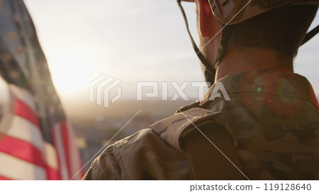 American Serviceman Watches The Flag Waving At Sunset American Serviceman Watches The Flag Waving At Sunset 119128640