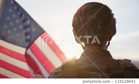 American Military Observes The US Flag At Sunset During Veteran Day Holiday American Military Observes The US Flag At Sunset During Veteran Day Holiday 119128641