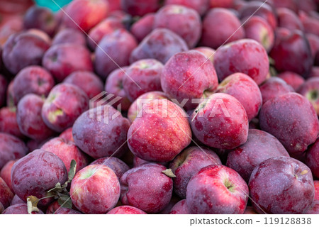 red apples displayed on a farmer's market counter 119128838