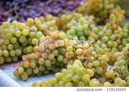 grapes displayed on a farmer's market counter 119128848