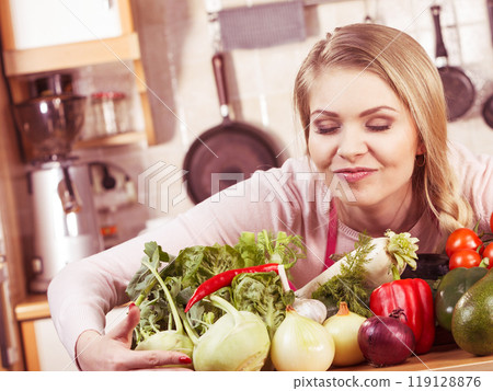 Woman having vegetables on table Woman having vegetables on table 119128876