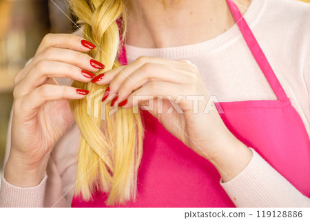 Woman making braid on blonde hair Woman making braid on blonde hair 119128886