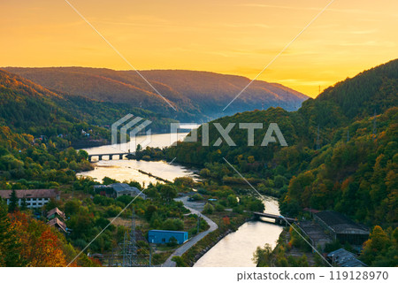 mountain river at dusk. landscape of romania in autumn. bridge over somes river in apuseni mountains in fall season. beautiful scenery of european countryside mountain river at dusk. landscape of romania in autumn. bridge over somes river in apuseni mountains in fall season. beautiful scenery of european countryside 119128970
