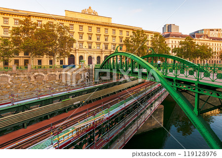 vienna, austria - 17 oct 2019: zollamtssteg and zollamtsbrucke bridge over the wien river in evening light. beautiful architecture of europe in fall season. popular travel destination and landmark. vienna, austria - 17 oct 2019: zollamtssteg and zollamtsbrucke bridge over the wien river in evening light. beautiful architecture of europe in fall season. popular travel destination and landmark. 119128976