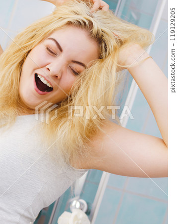 Happy fresh blonde woman in bathroom 119129205