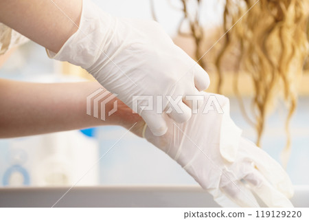 Woman with white latex gloves in bathroom Woman with white latex gloves in bathroom 119129220