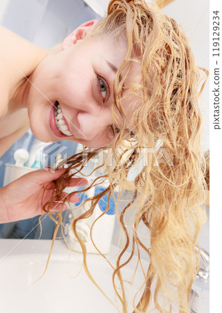 Woman having wet blonde hair Woman having wet blonde hair 119129234