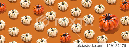 Pattern of orange and white pumpkins with one big pumpkin on orange background. long horizontal wallpaper banner, ornament Pattern of orange and white pumpkins with one big pumpkin on orange background. long horizontal wallpaper banner, ornament 119129476