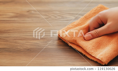Hand Cleaning Wooden Surface with Orange Cloth in a Home Setting, AI 119130026