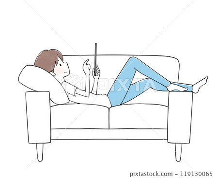 Man relaxing on sofa looking at tablet 119130065