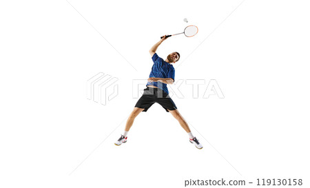 Athletic man, badminton player poised to strike, showcasing agility and dynamic motion against white studio background. Athletic man, badminton player poised to strike, showcasing agility and dynamic motion against white studio background. 119130158