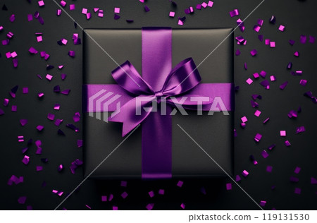 A beautifully wrapped black gift box with a purple ribbon surrounded by purple confetti 119131530