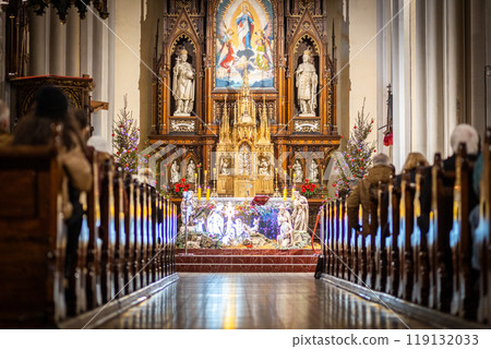Church altar during Christmas Mass with The Nativity scene. The Catholic Orthodox Christmas holiday in Europe Church altar during Christmas Mass with The Nativity scene. The Catholic Orthodox Christmas holiday in Europe 119132033