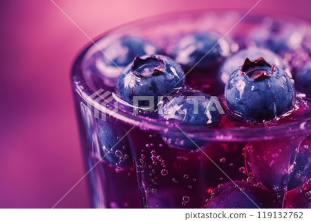 Fresh blueberry drink with bubbles in a glass against purple background Fresh blueberry drink with bubbles in a glass against purple background 119132762
