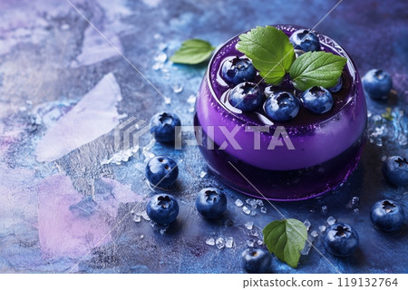 Vibrant blueberry jelly dessert with fresh leaves mint on artistic background 119132764