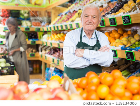 Senior man supermarket worker standing in salesroom Senior man supermarket worker standing in salesroom 119134006
