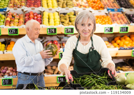 Woman supermarket worker and old man customer in salesroom Woman supermarket worker and old man customer in salesroom 119134009