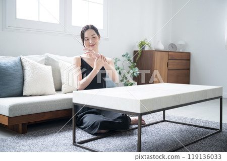Wide-angle image of hands applying cream that can be used to combat rough, dry hands in winter 119136033