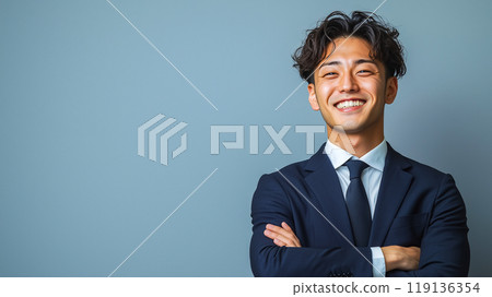 Confident businessman smiling with arms crossed 119136354