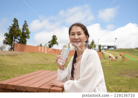 Senior woman hydrating at Lake Biwa Valley 119136710