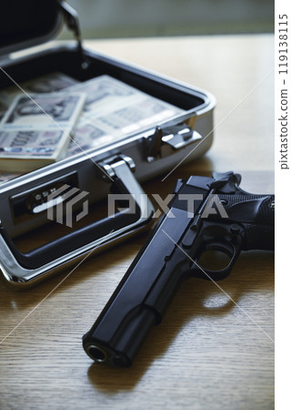 A gun and a stack of bills in an attaché case A gun and a stack of bills in an attaché case 119138115